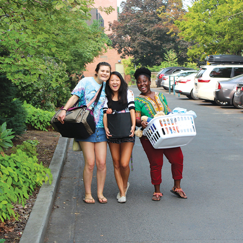 Three students smiling during move in at Whitman College