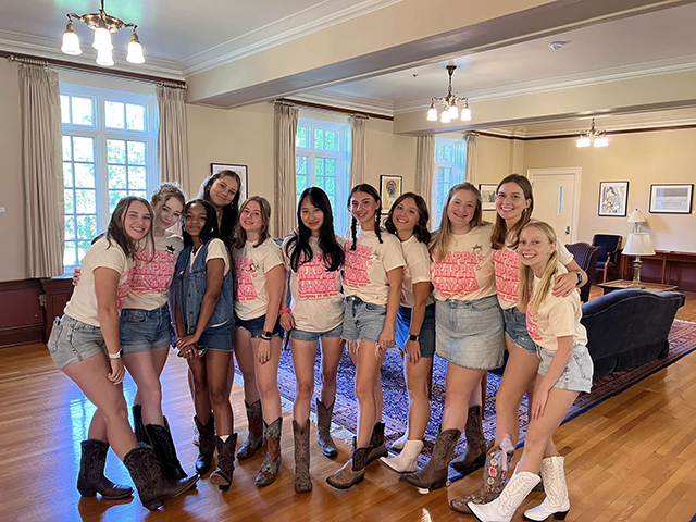 A group of Kappa Kappa Gamma members wearing white shirts and jean shorts.