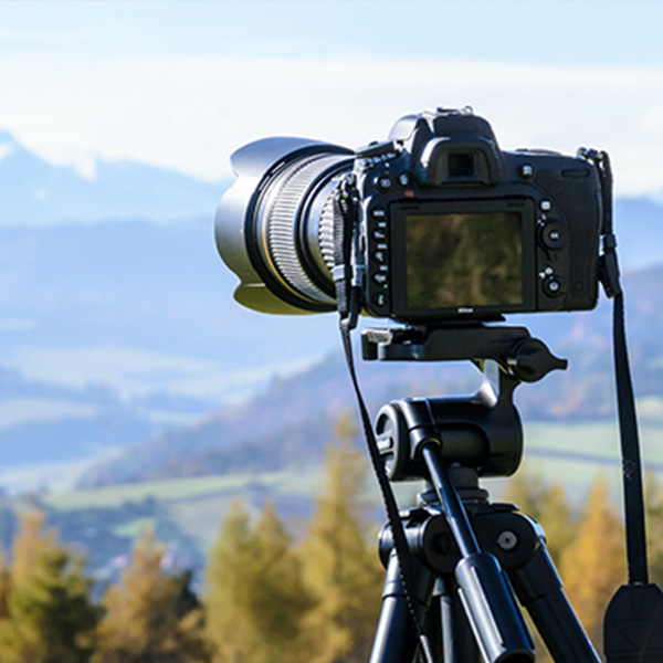 A camera on a tripod overlooking a landscape