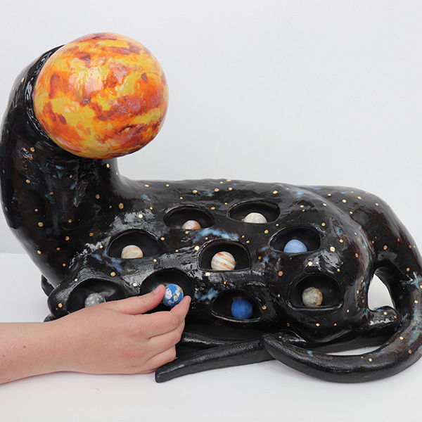 Ceramic art involving planets and a sun