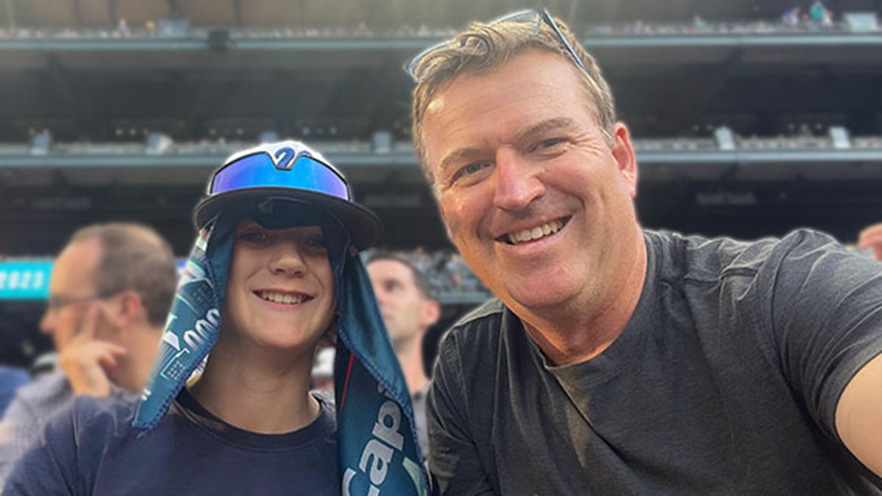 Andrew Reed ’97 cheers on the Mariners with his son Julian.