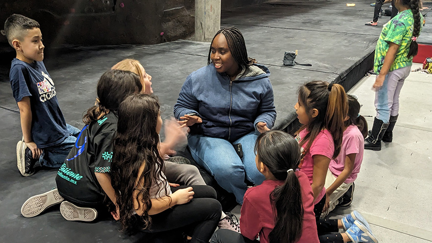 Margaret Kanyoko with a group of elementary students at the climbing wall located at Whitman College.