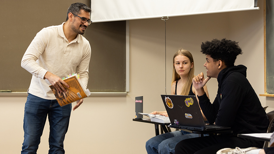 Associate Professor of Hispanic Studies Aarón Aguilar-Ramírez’s (left) First Year Seminar, Monsters and Monstrosity (GENS-176), students discussing how societies around the world create, fear and reinterpret monsters.