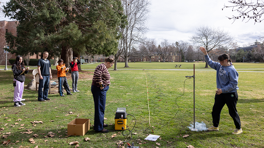 Students from Geophysics (GEO-310) perform a seismic survey in front of the Hall of Science.