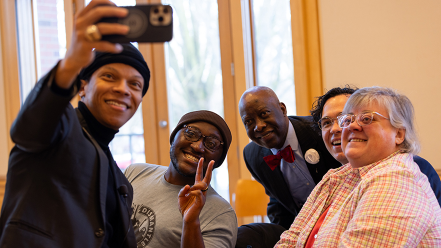 Dr. Terrell Strayhorn taking a selfie with faculty and staff.