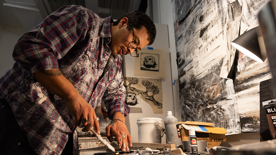 Mario Salazar '25 working on a project in his senior art studio in the Fouts Center for the Visual Arts.