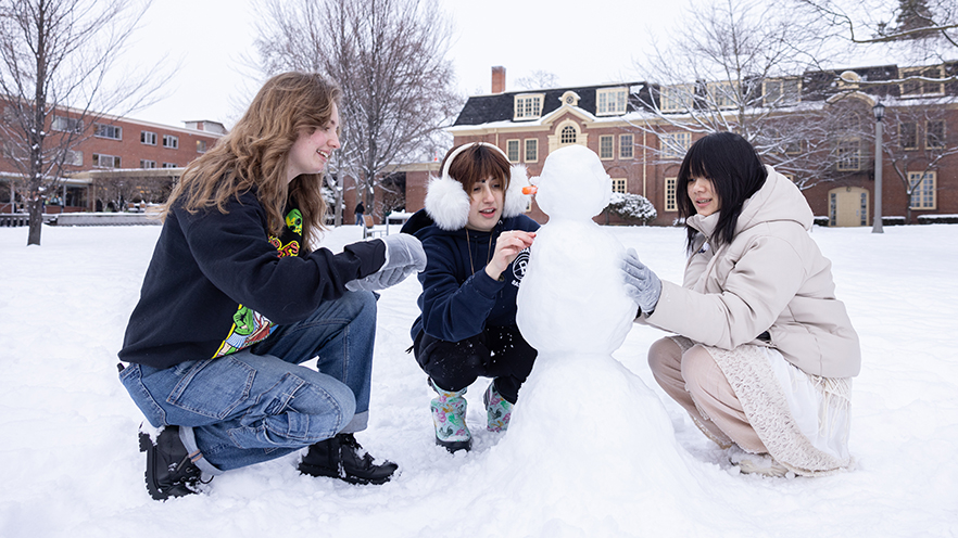 Whitman students building a snowman!