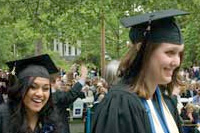 Two graduates smiling at Commencement.