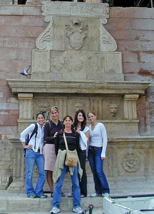 Standing in front of a Roman fountain in Assisi, Italy, are Whitman