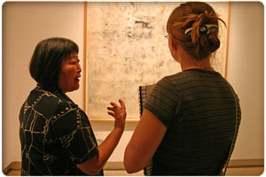 Keiko Hara discusses art show with one of the guests at the current show's opening.
