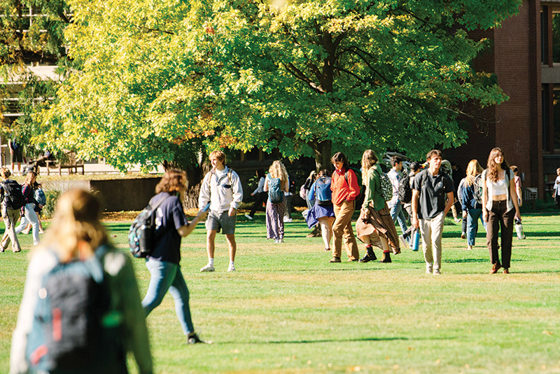 Students walking across Ankeny Field on Whitman College campus 