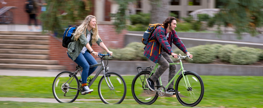 students cycling on campus