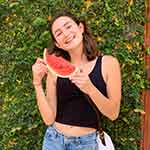 Lauren Mendoza smiling with a slice of watermelon