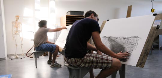 two students work on their drawings