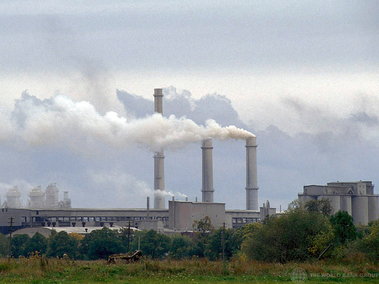 Photograph of a factory with smokestacks
