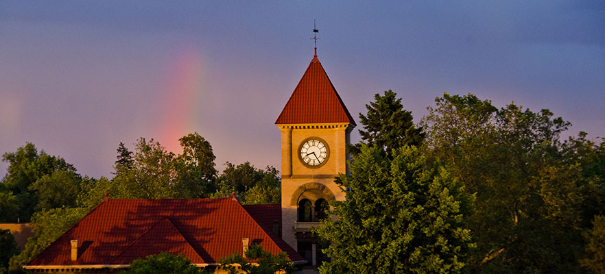 Memorial Building on Whitman College campus with a rainbow in the sky