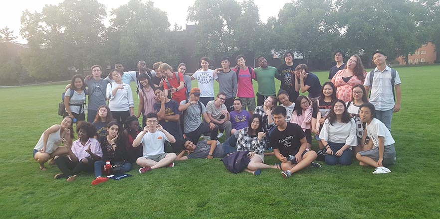 A group of international students pose on Ankeny Field.