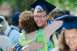 graduate hugging a family member