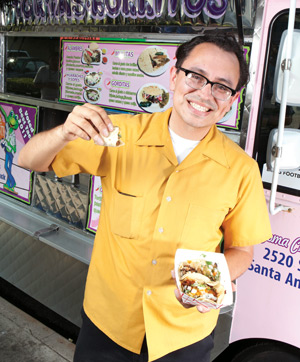 Gustavo Arellano in front of a taco truck