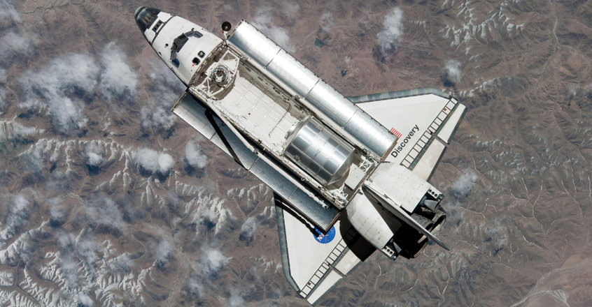 Space shuttle in orbit with cargo bay doors open