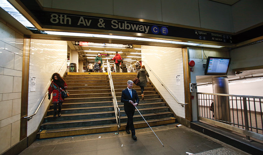 Kirk Adams walking within a New York City subway station