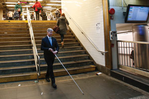 Kirk Adams walking within a New York City subway station