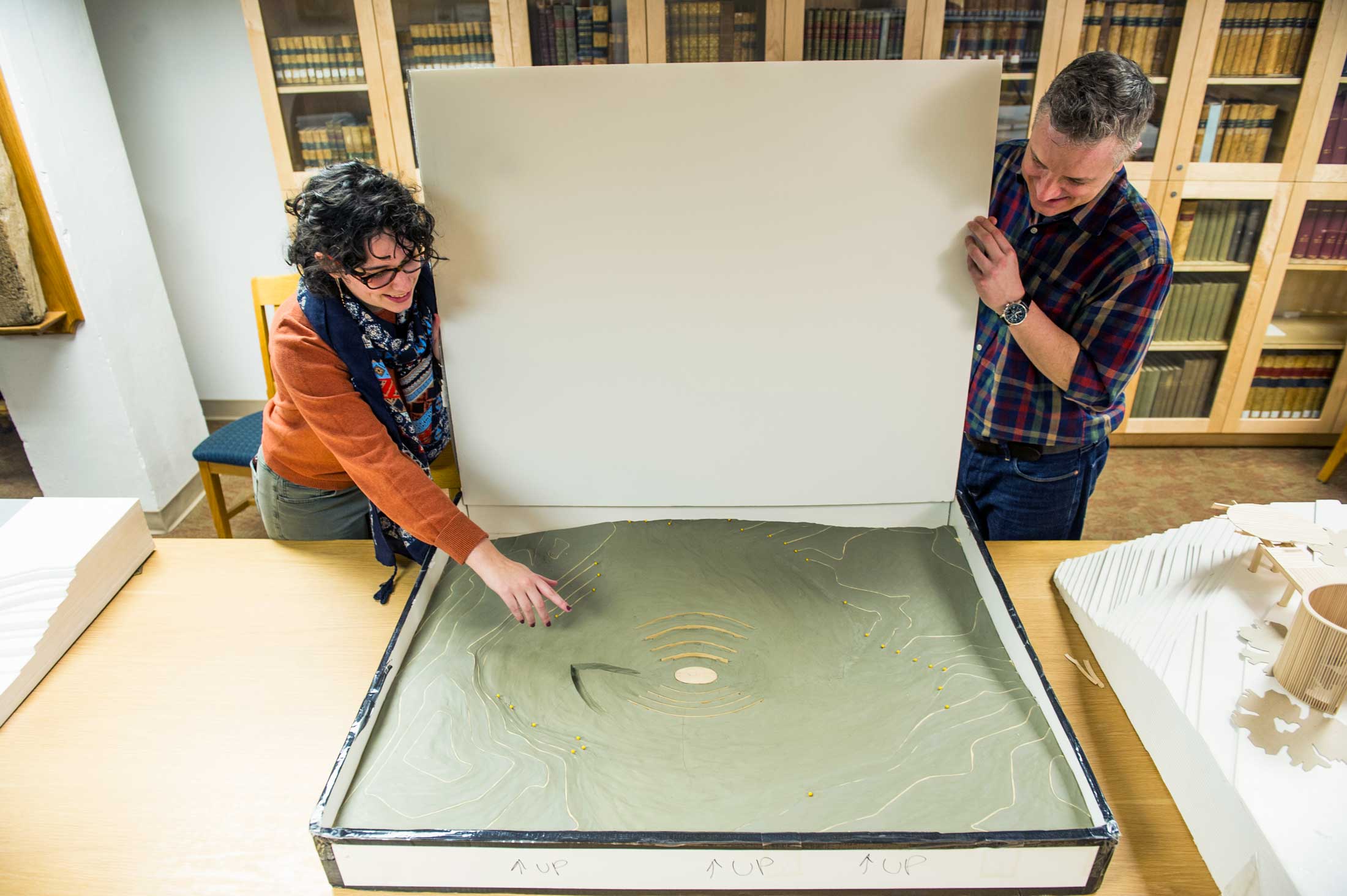 Laura Rivale '19 and Professor Reynolds examine an architectural model in the archives. 