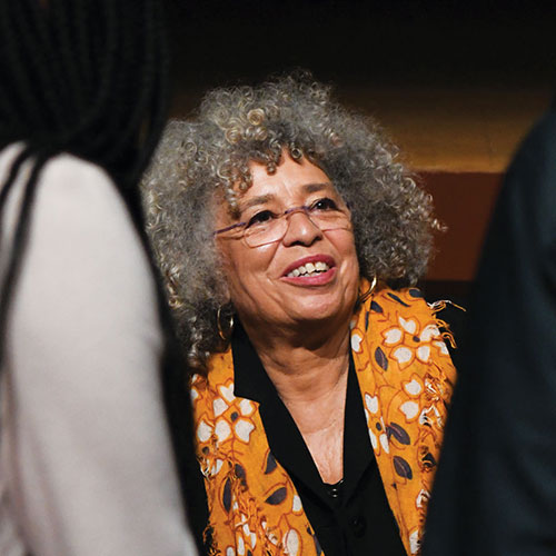 Angela Davis talking with a group