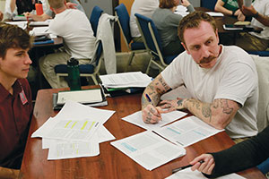 Whitman College students speaking with a prison inmate