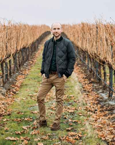 Todd Harrington ’09 standing outside at a vineyard