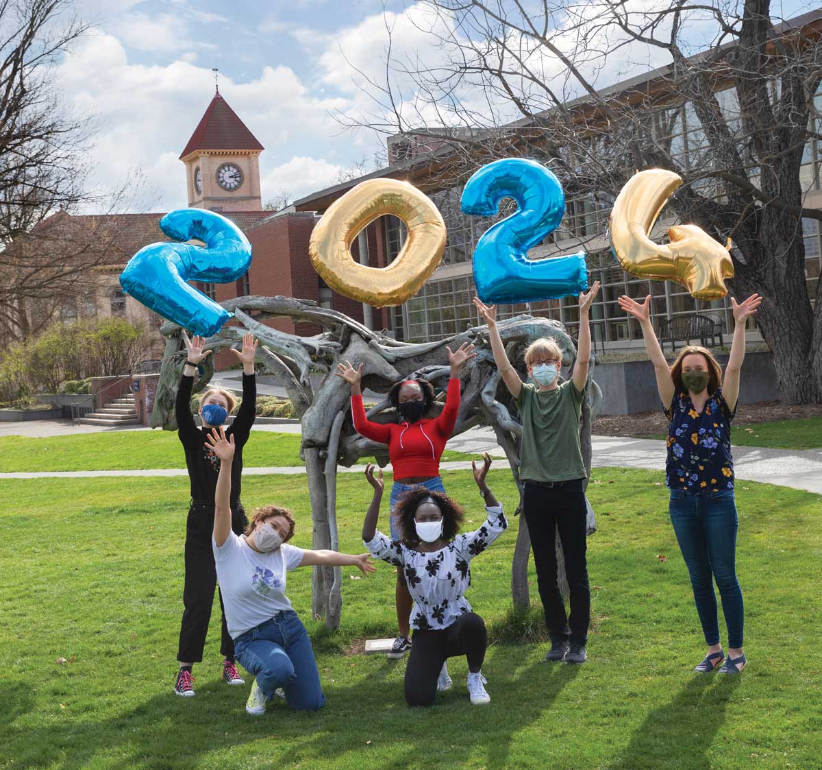 A group of students holding "2024" balloons