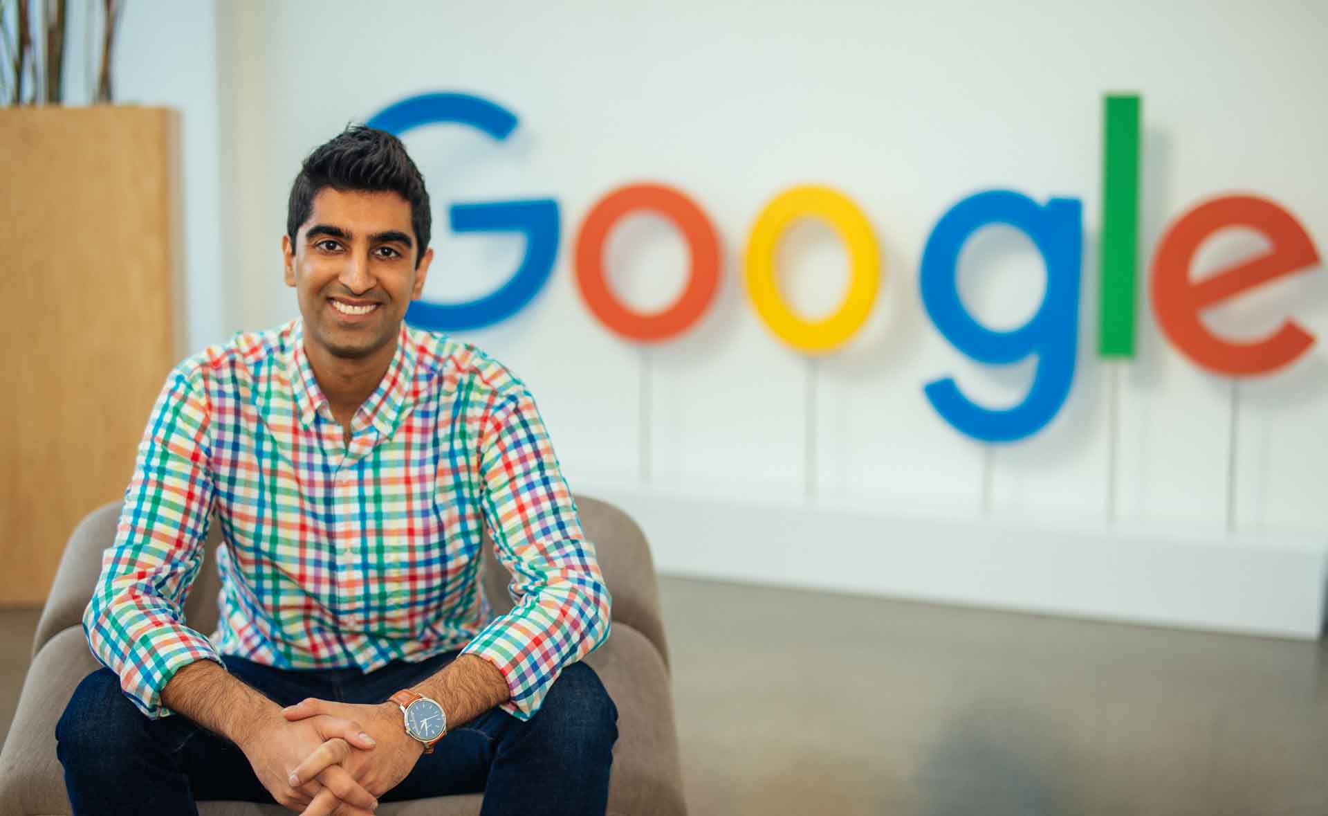 Al Rahim Merali sitting in front of a Google sign