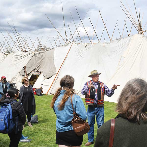 Whitman alum Roger Amerman teaches “Long Tent 101” in front of the Plateau Long Tent—believed to be the first ever built on a college campus—that stood on Ankeny Field from April 18-26, 2022. 