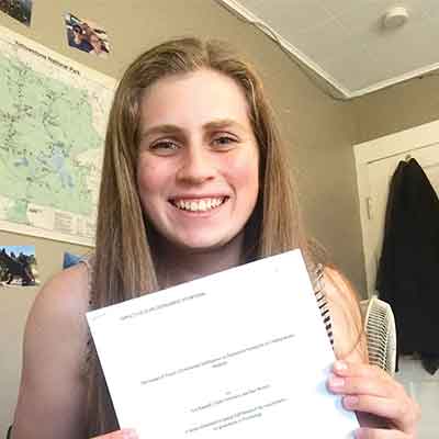 Emily Solomon '21 holding their thesis.