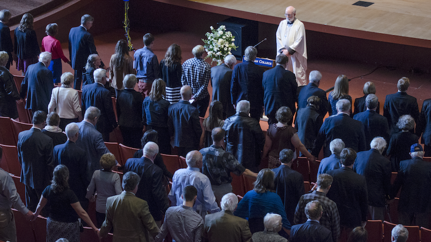 Rev. Andrew Cooley, interim rector at St. Paul’s Episcopal Church in Walla Walla, leads hundreds of attendees in prayer for the late Pete Reid, aka “Mr. Whitman,” last Saturday in Cordiner Hall. 
