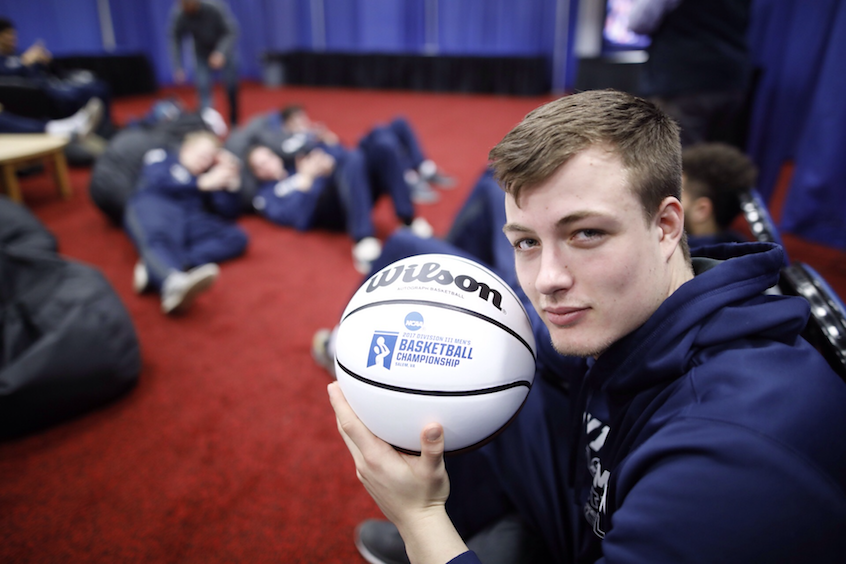 Robert Colton '19, a wing player and economics major, poses with a keepsake.