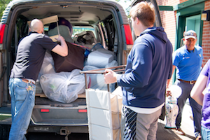 Cory Kiesz, custodial supervisor (left); Adam Dawson, resident director of the interest house community (center); and Carlos Ruiz, assistant custodial supervisor, load the college’s custodial van with one type of care package after another from Whitman students for community members. 