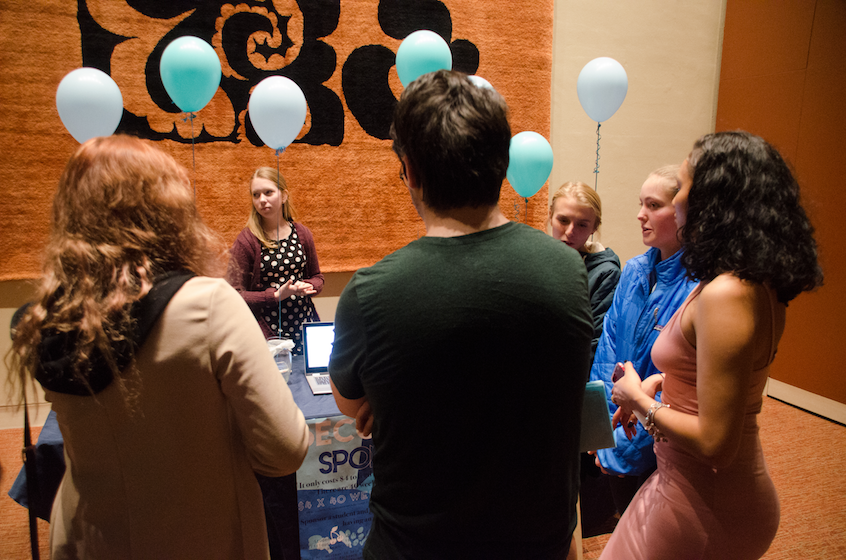 Geology-environmental studies major Chaney Coman ’19 (center left) and Stella Martindale ’20 (second from right) staff the donation table during intermission.