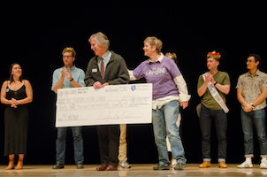 Mr. Whitman contestants on stage with giant check