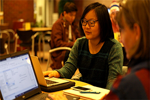 A photo of Erina Horikawa sitting at a computer.