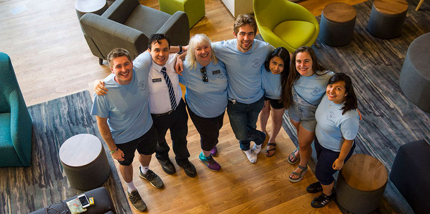 A group of Residence Life staff stand in the foyer of Stanton Hall.
