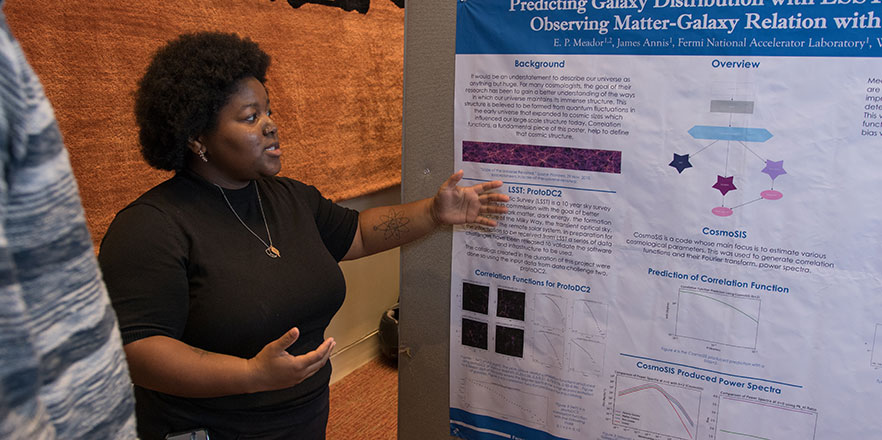 A student presents her poster at the Undergraduate Conference.