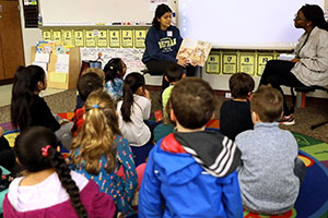 Whitman College students read a story to a group of first-graders.