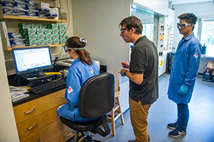 Kaia Martin and Jack Chen work in a chemistry laboratory with Mark Hendricks.