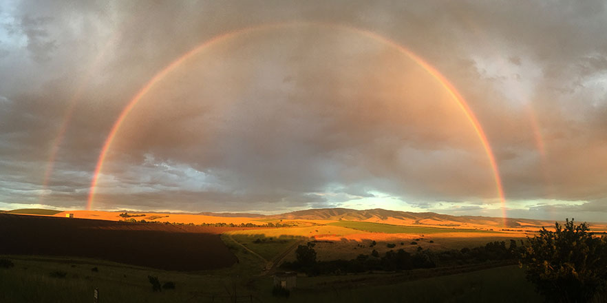 A rainbow over the foothills of the blue mountains.