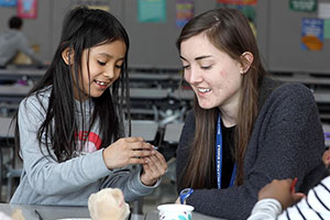 Kimberly Taylor works with a student in a classroom.