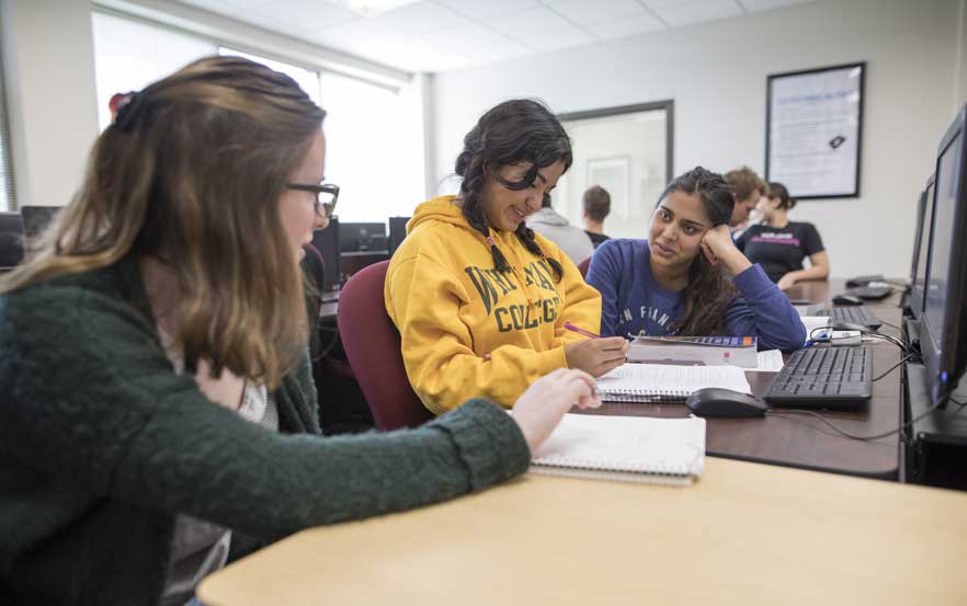 Students collaborate in a computer science classroom.