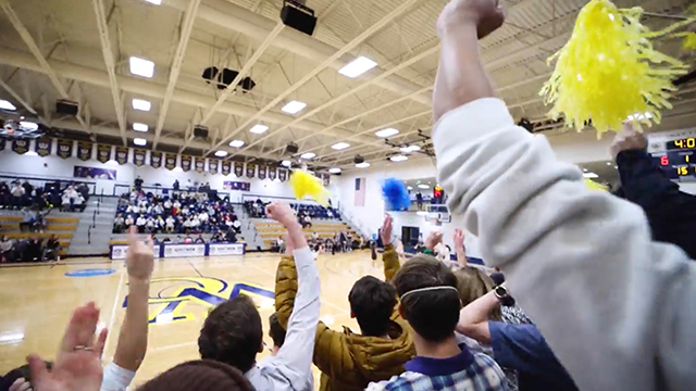 A crowd cheering at a Whitman athletics event.