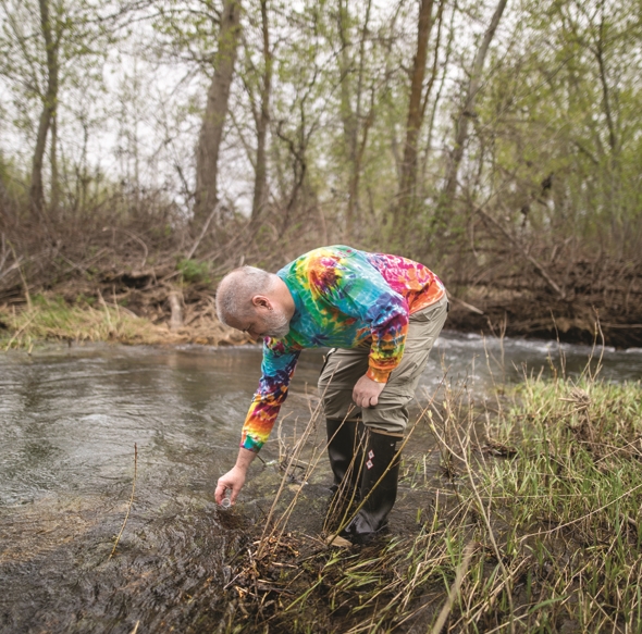 Dunnivant wades into Mill Creek, near Rooks Park in Walla Walla, to collect a water sample last month.