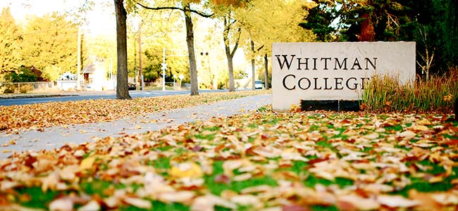 Whitman college sign with fall leaves